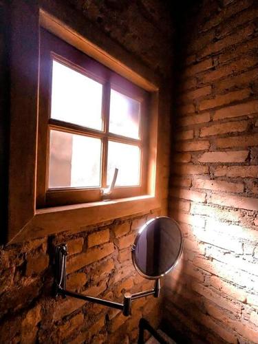 a bathroom with a mirror and a window at Loft Industrial in Santo André