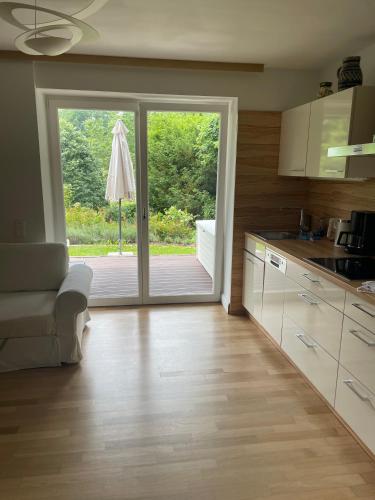a kitchen with a sliding glass door to a patio at Rose Garden Retreat Private Terrace Baden-Baden in Baden-Baden