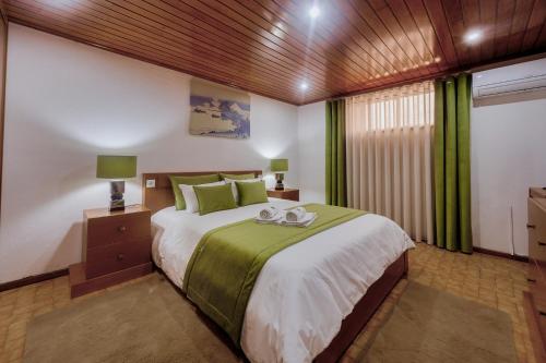 a bedroom with a large bed and a window at CASAL ESPINCHO - Castelo de Paiva, São Martinho de Sardoura in Castelo de Paiva