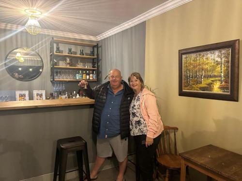 a man and a woman standing in a bar at Achab Camping Camp site in Usakos