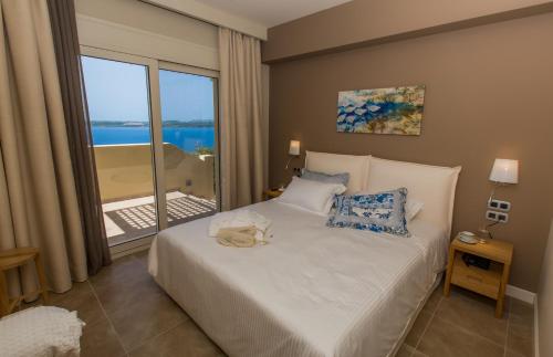 a bedroom with a bed with a view of the ocean at Ionian Vista Villas in Argostoli