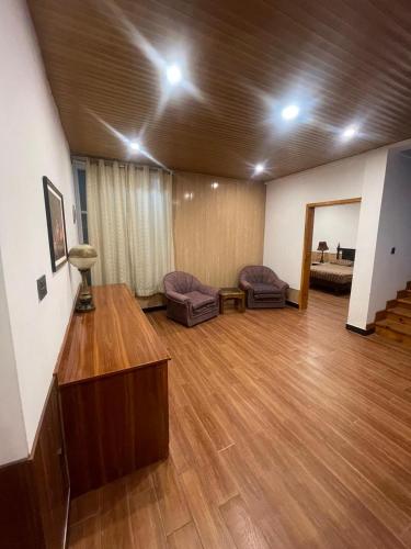 a large living room with a wooden floor at Nathia Lodge Mountain View Hotel & Guest House Nathia Gali in Abbottābād