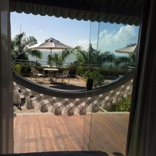 a view of a patio with a table and umbrella at Pipa Mar Hotel in Pipa