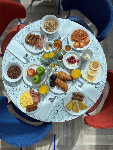 a table with plates of breakfast food on it at Holiday Inn Express Windsor by IHG in Windsor