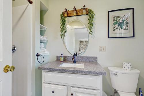 a bathroom with a sink and a mirror at Hobby Hops Farmhouse in Northport