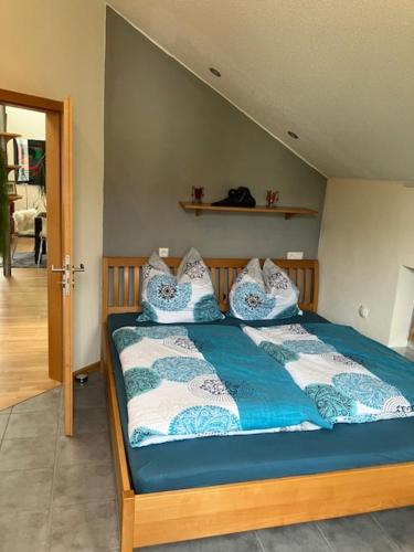 a bedroom with a bed with blue and white pillows at Traumhaftes Loft 70 qm * Wohlfühlen in Passau * in Passau