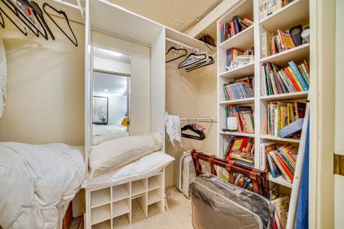 a bedroom with a mirror and a bed and bookshelves at 8 Mi to Dtwn Seattle Pet-Friendly Apt with Hot Tub in Mercer Island