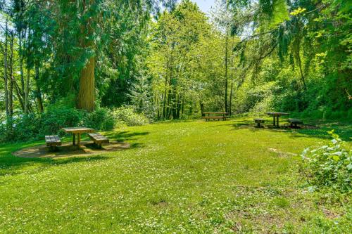 two picnic tables and benches in a park at 8 Mi to Dtwn Seattle Pet-Friendly Apt with Hot Tub in Mercer Island