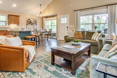 a living room with couches and a table at Walk to Dtwn Waynesville Home with Deck! in Waynesville