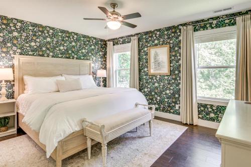 a bedroom with a large bed with floral wallpaper at Walk to Dtwn Waynesville Home with Deck! in Waynesville