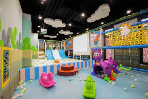 a play room with a playground with toys in it at Hilton Shanghai Songjiang Guangfulin in Songjiang