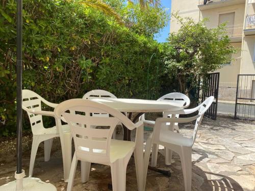 a white table and chairs sitting on a patio at Ottocento - Casa Brunori in Follonica