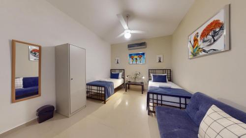 a living room with two beds and a couch at Hotel Tau Art Residence in Santo Domingo