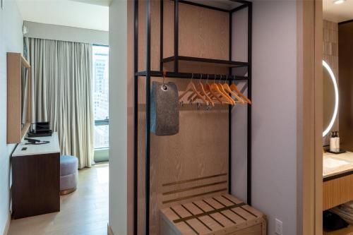 a kitchen with a refrigerator in a room at Tempo By Hilton New York Times Square in New York