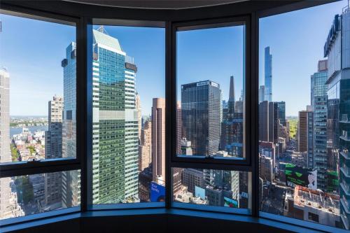 a view of a city skyline from an office window at Tempo By Hilton New York Times Square in New York