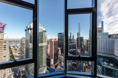 a view of the city from the window of a skyscraper at Tempo By Hilton New York Times Square in New York