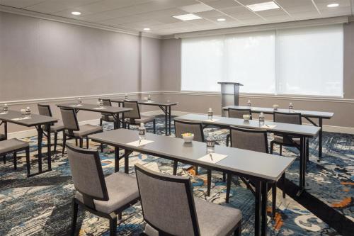 a conference room with tables and chairs and a large window at The Chifley Houston, Tapestry Collection by Hilton in Houston