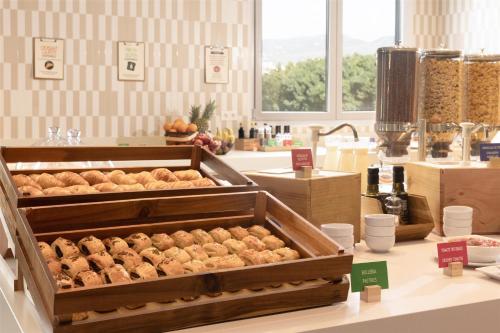 a counter with two trays of food in a store at Hampton By Hilton Malaga Martiricos in Málaga