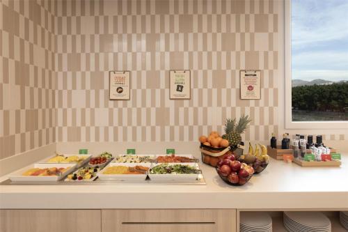 a buffet with many different types of food on a counter at Hampton By Hilton Malaga Martiricos in Málaga