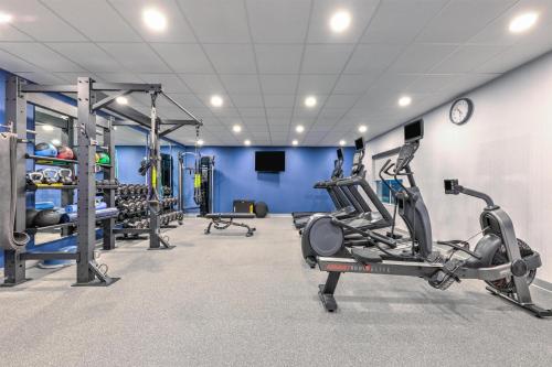 a gym with several tread machines and a clock at Hampton Inn & Suites by Hilton Little Rock Airport in Little Rock