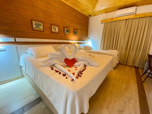 a bedroom with a bed with a heart on it at Encanto Rural in Bella Vista
