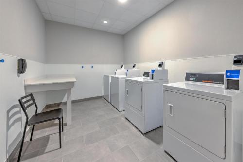 a laboratory with white counters and a chair in a room at Hampton Inn & Suites by Hilton Little Rock Airport in Little Rock