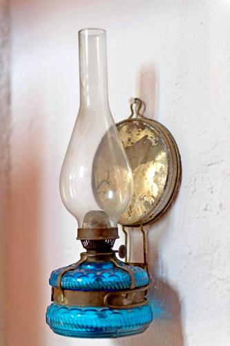 a glass vase sitting next to a clock at Elounda Traditional Homes of Crete in Elounda