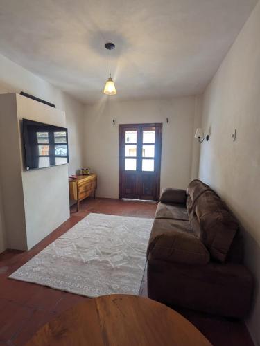a living room with a couch and a table at Casa del Rey in Taxco de Alarcón