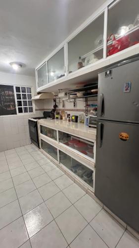 a kitchen with a stainless steel refrigerator in a kitchen at Casamaya Hostel & Diving in Cozumel