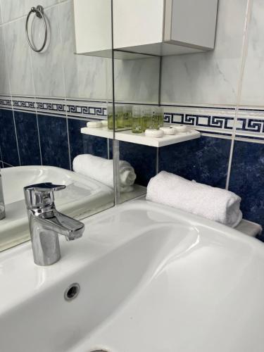 a bathroom with a white sink and a mirror at Apartman Jugo in Kaštela