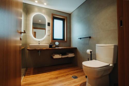 a bathroom with a toilet and a sink at Quinta S Pedro - Arouca Valley in Arouca