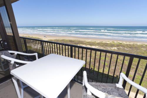 a table and chairs on a balcony with the beach at Sea Vista in South Padre Island