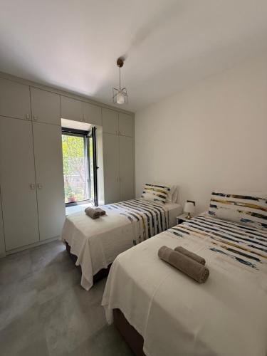 a bedroom with two beds and a window at Villa Adventure in Bodrum City