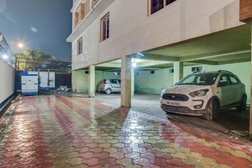 a car parked in a parking lot next to a building at Collection O Palm Tree Lodge in Siliguri