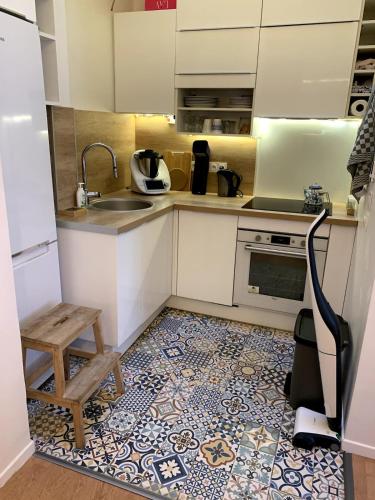 une petite cuisine avec un évier et une cuisinière dans l'établissement Appartement Confort - Puteaux La Défense, à Puteaux