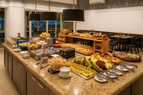 a buffet of fruits and vegetables on a counter at BOOK A FLAT Jardim Paulista em Hotel in Sao Paulo
