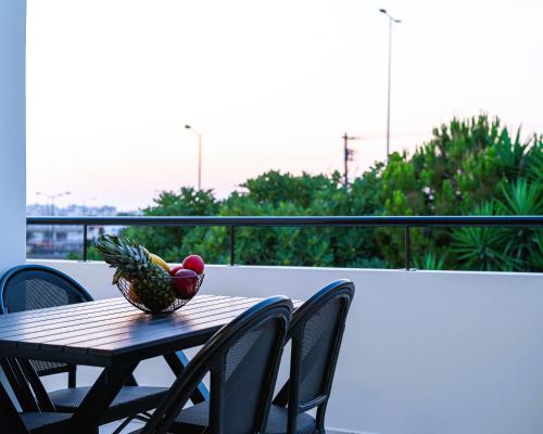a bowl of fruit on a table on a balcony at Family Friendly Luxury Apartment in Néa Alikarnassós