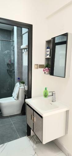 a bathroom with a toilet and a sink and a shower at American Hospice in Nairobi