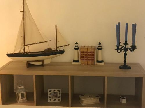 a model of a sail boat on a table at Le jardin secret de Laura in Lorgues