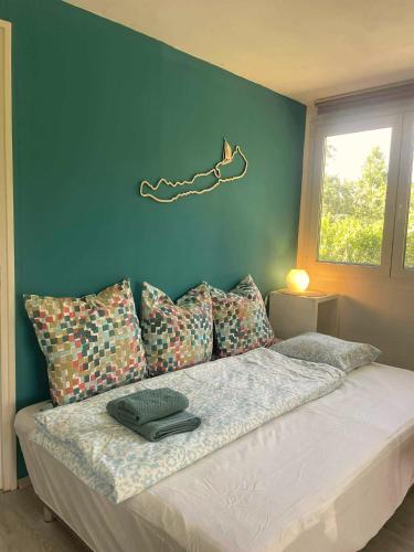 a bedroom with a bed with a blue wall at Bodorka - Csak a Tiéd! in Balatonakarattya