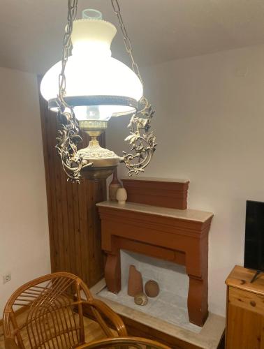 a chandelier hanging over a fireplace in a room at Adele house in Skopelos Town