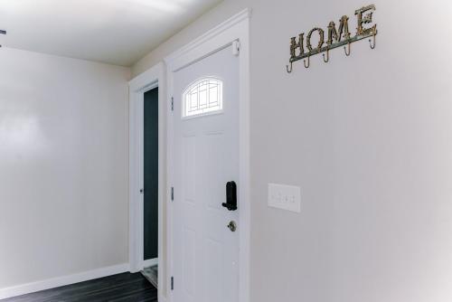 a hallway with a white door and a window at 4-bedroom Burlington with AC & Wifi in Burlington