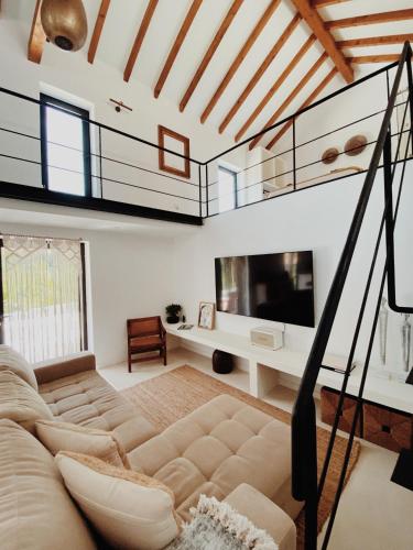 a living room with a loft bed and a couch at Lusterra Grounds in Amarante