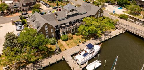 an aerial view of a house with a boat in the water at The Tranquil House Inn in Manteo