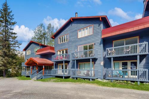 a large house with a red roof at Girdwood Lodge in Girdwood