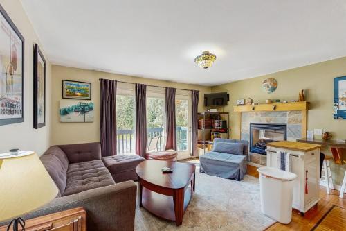 a living room with a couch and a fireplace at Girdwood Lodge in Girdwood
