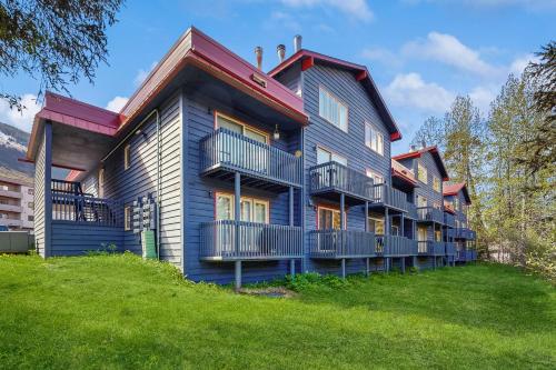 a large house with blue paint on the side of it at Girdwood Lodge in Girdwood