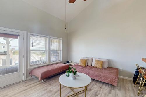 a living room with a bed and a table at Seashore Cove in North Topsail Beach