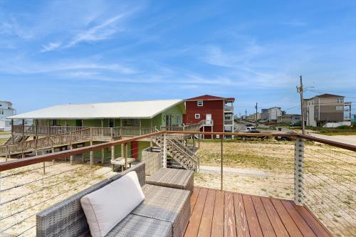 a house with a couch on a wooden deck at Seashore Cove in North Topsail Beach