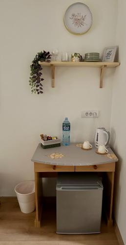 a wooden table with a counter and a clock on the wall at Kruna Palića in Palić